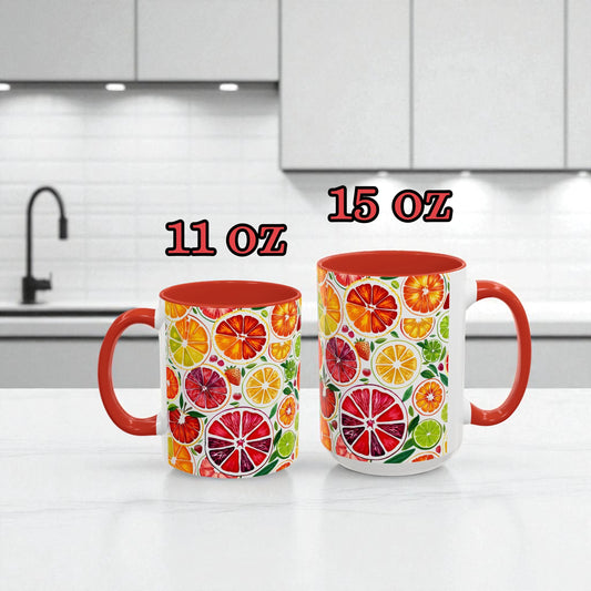 Two mugs with fruit pattern on a kitchen counter, labeled 11 oz and 15 oz.