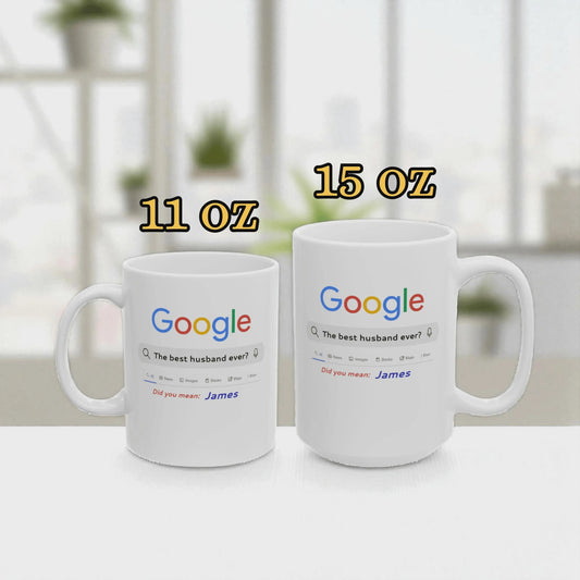 Two white mugs with Google logo and text, one labeled 11 oz and the other 15 oz, on a blurred indoor background.
