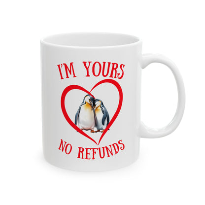 White mug with penguins in a heart and text 'I'm yours no refunds' on a white background