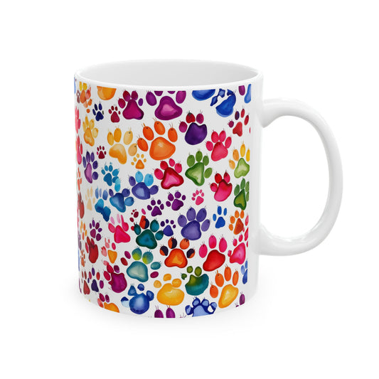 White mug with colorful paw print pattern on a white background