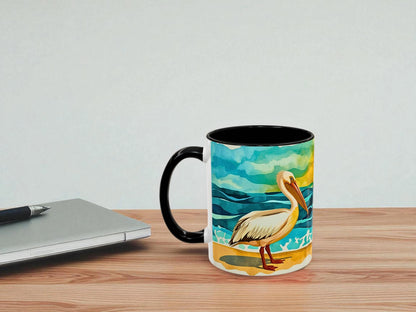 Mug with a pelican design on a wooden table next to a laptop.