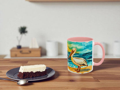 Mug with a pelican design on a wooden table next to a slice of cake.