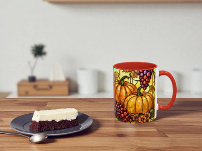 Decorative mug with pumpkins and grapes on a wooden table with a slice of cake.