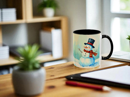 Mug with a snowman design on a wooden desk with a plant and tablet in the background