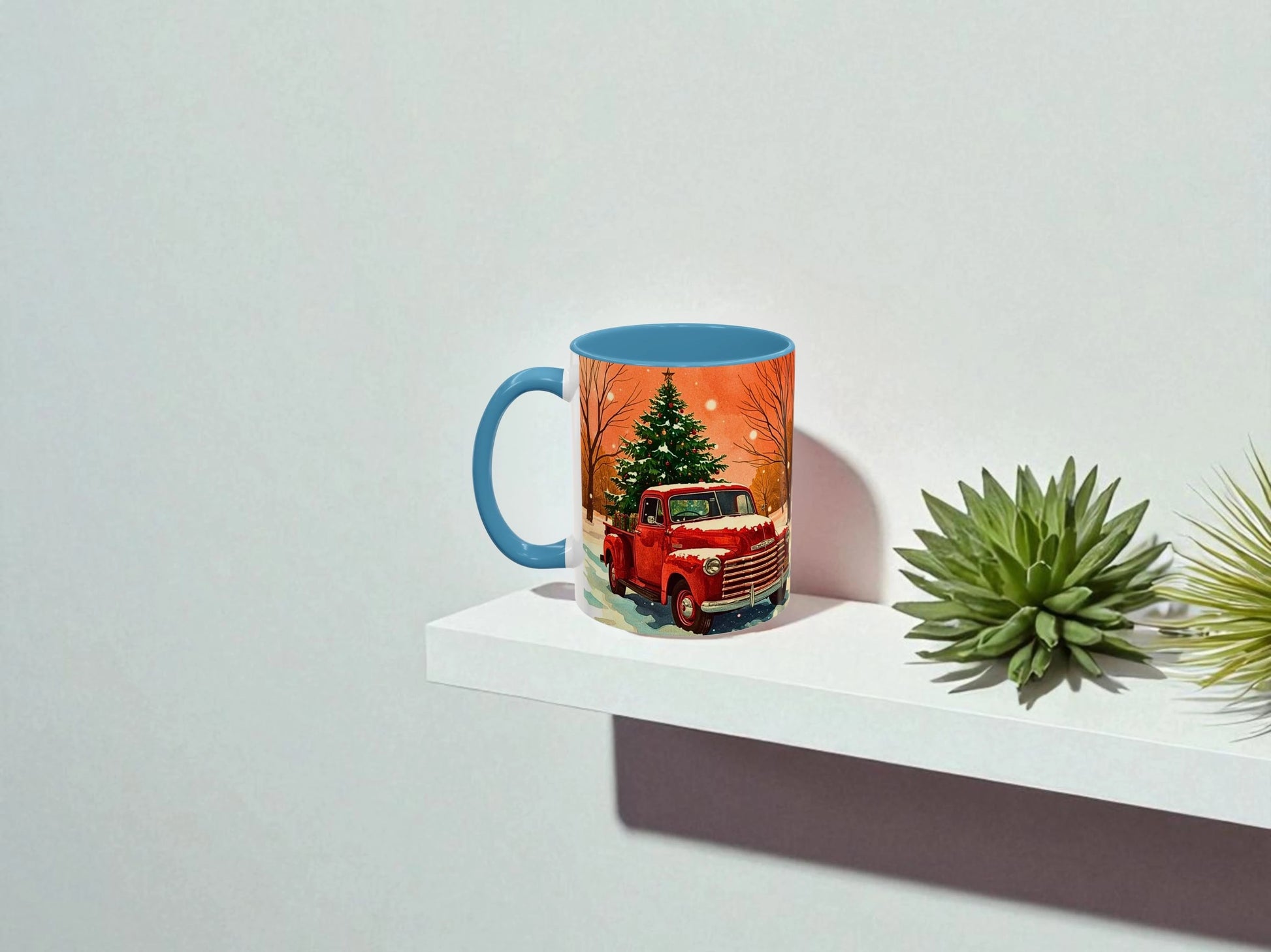 Mug with a red truck and Christmas tree design on a white shelf with plants.