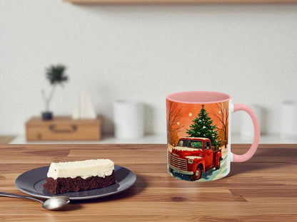 Mug with a festive design of a red truck and Christmas tree on a wooden table with a cake.