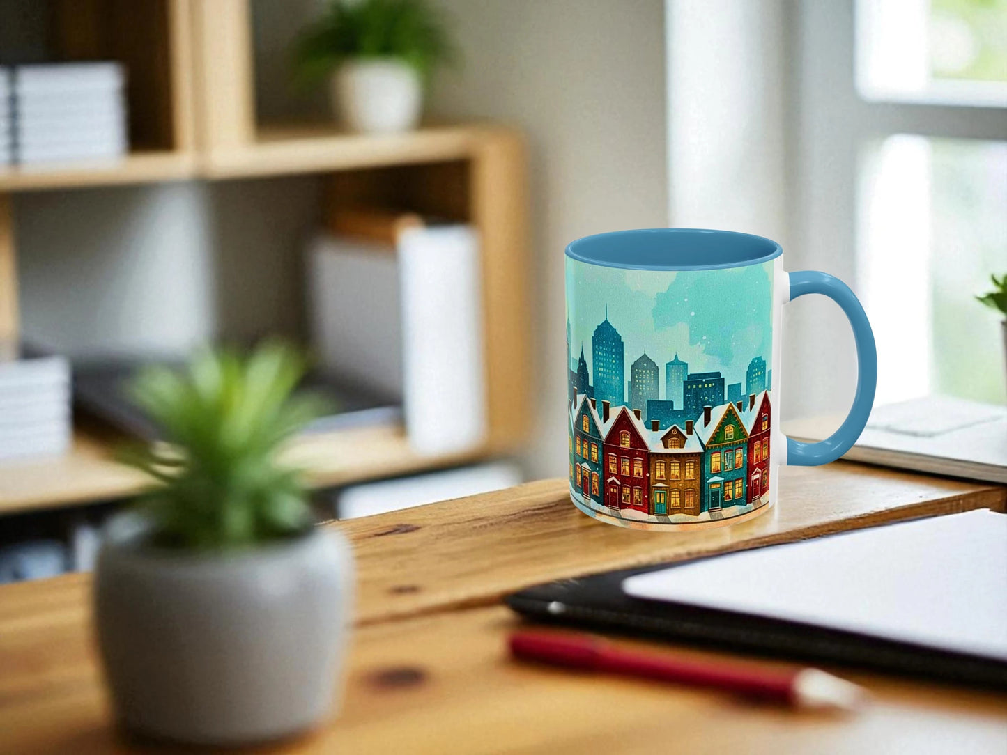 Colorful mug with a cityscape design on a wooden desk.