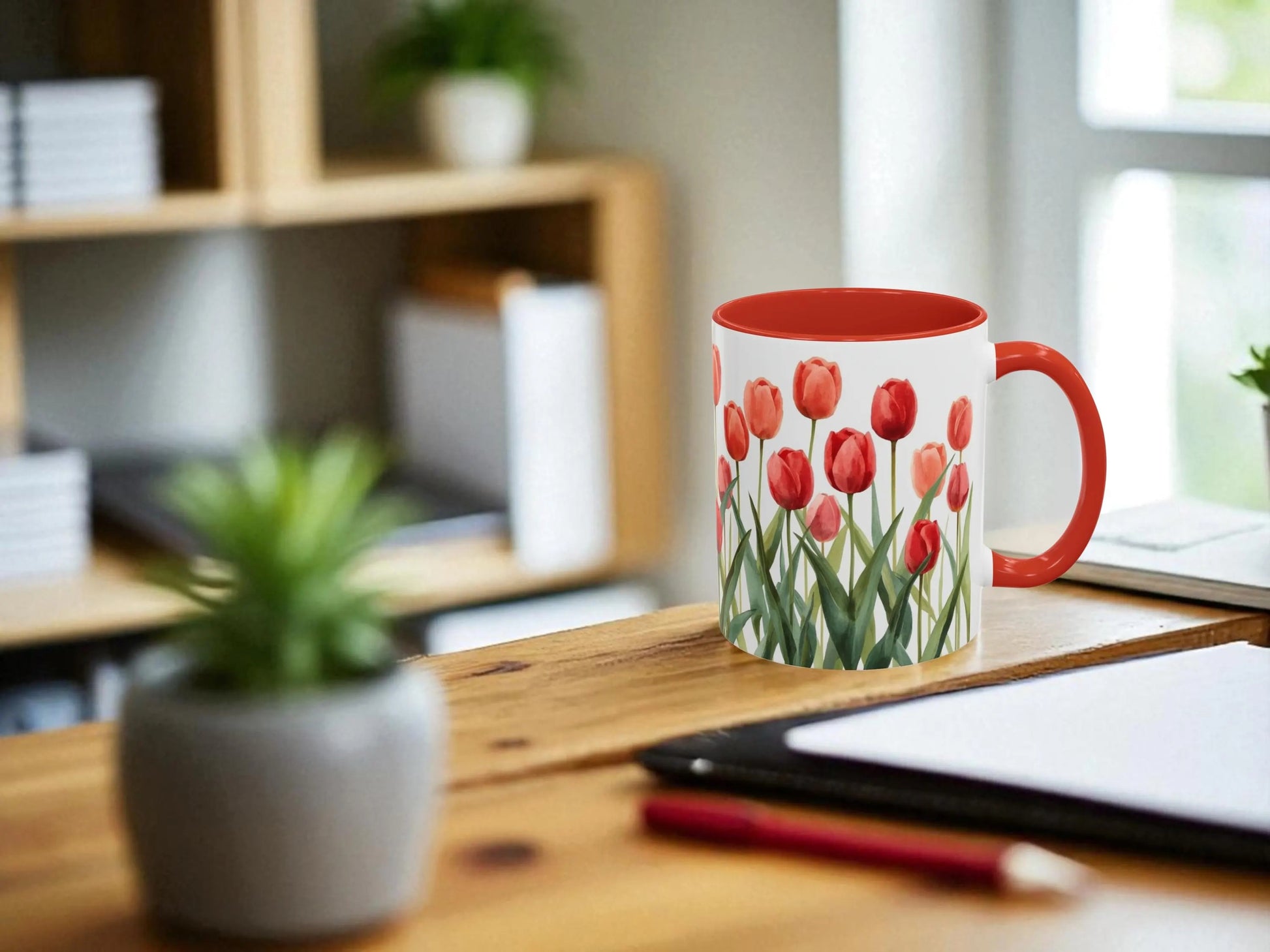 Mug with tulip design on a desk with office items