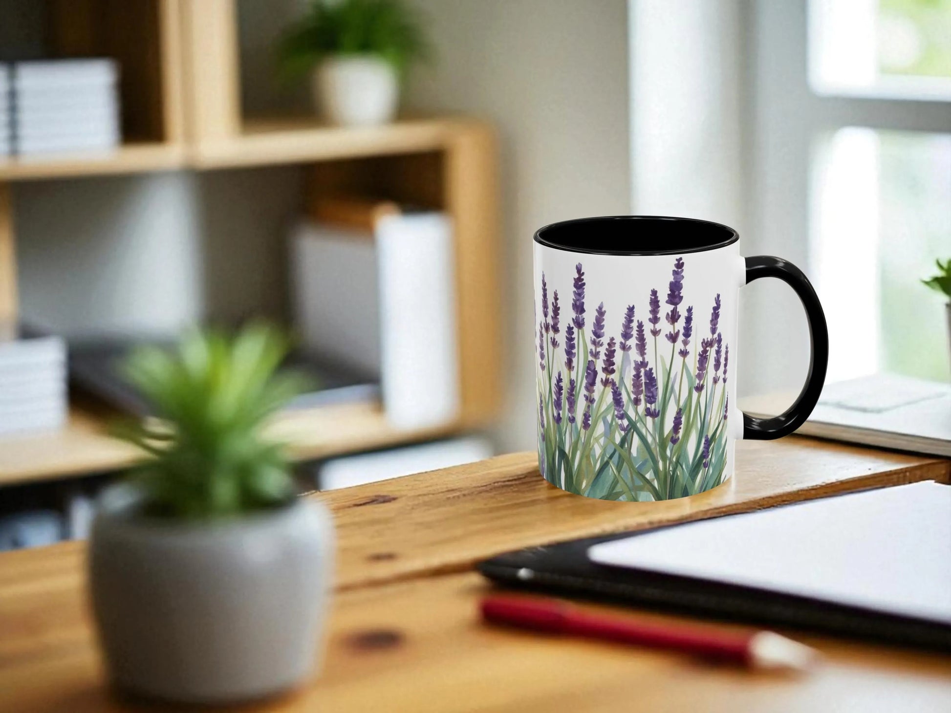 Mug with lavender design on a desk with a plant and tablet in the background