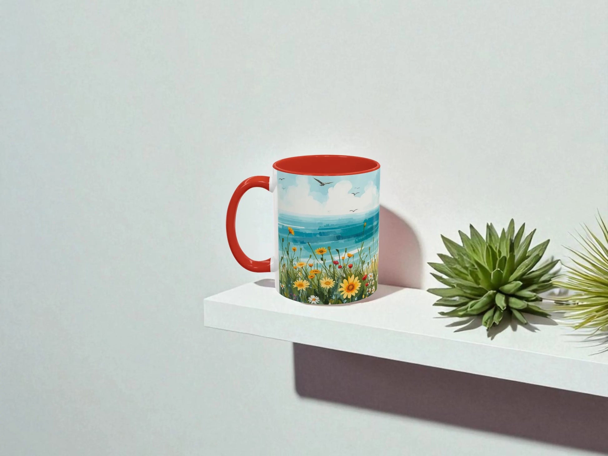 Mug with a scenic design on a white surface with a plant