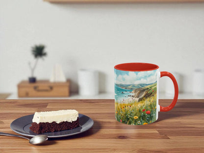 Mug with scenic design on a wooden table with a piece of cake.
