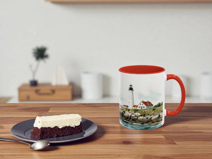 Mug with lighthouse design on a wooden table with a slice of cake.