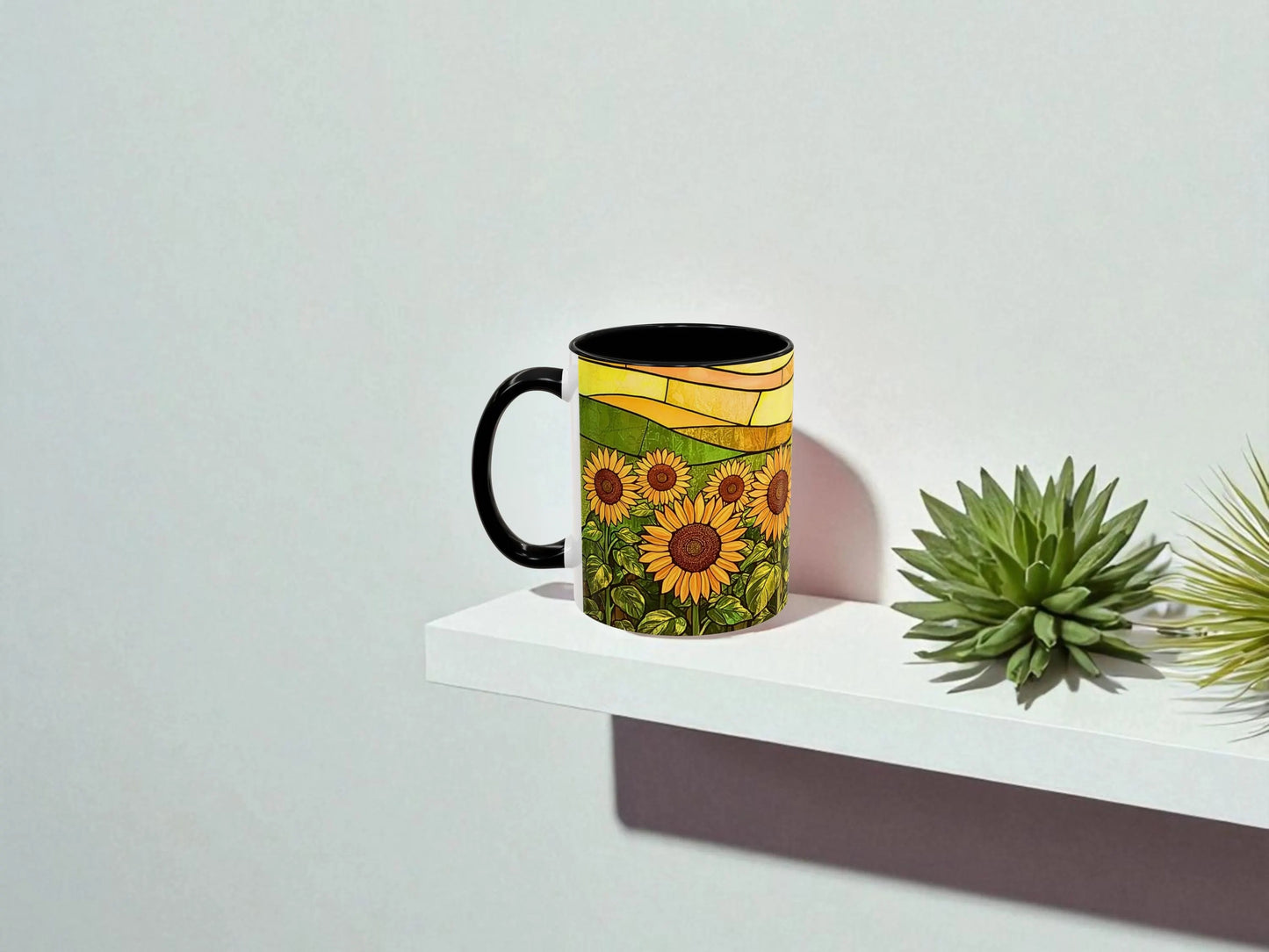 Mug with sunflower design on a white surface with a plant