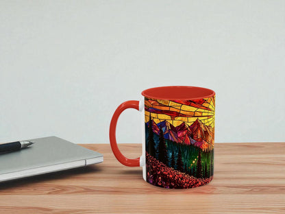 Mug with colorful design on a wooden table next to a laptop.