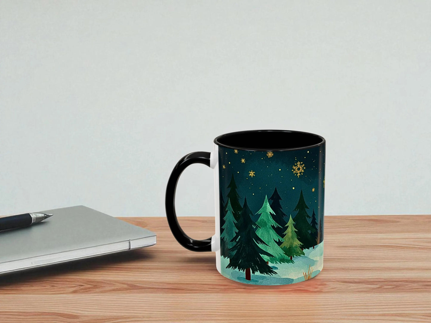 Mug with nature design on a wooden table next to a laptop
