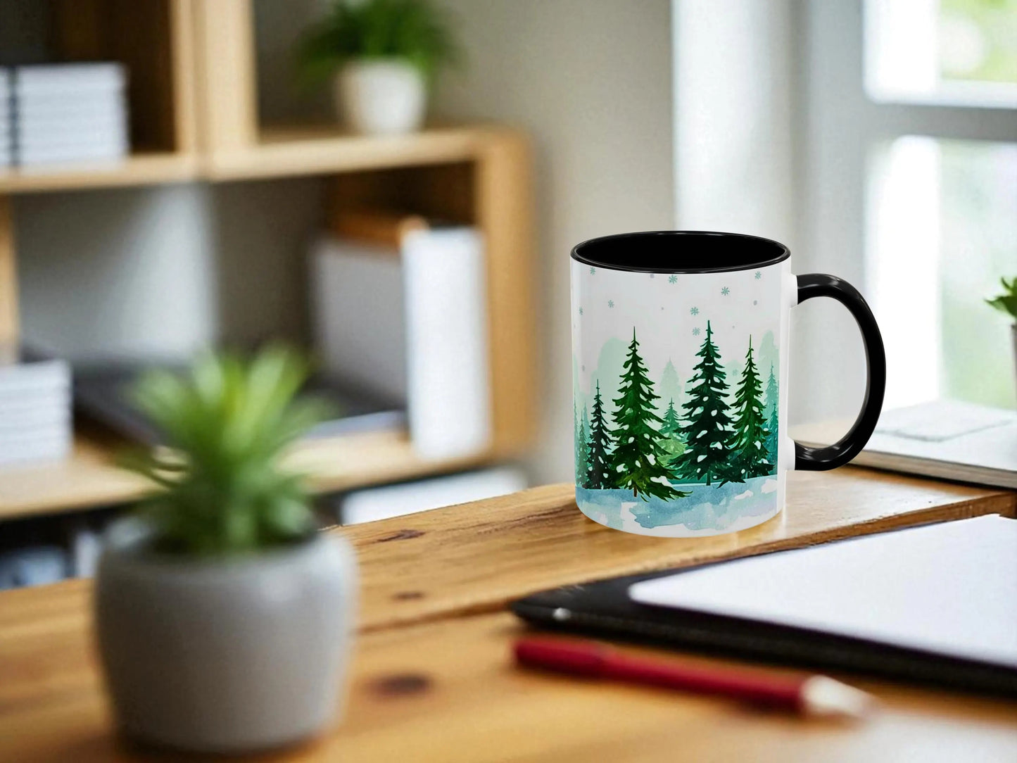 Mug with forest design on a desk with a plant and tablet in the background