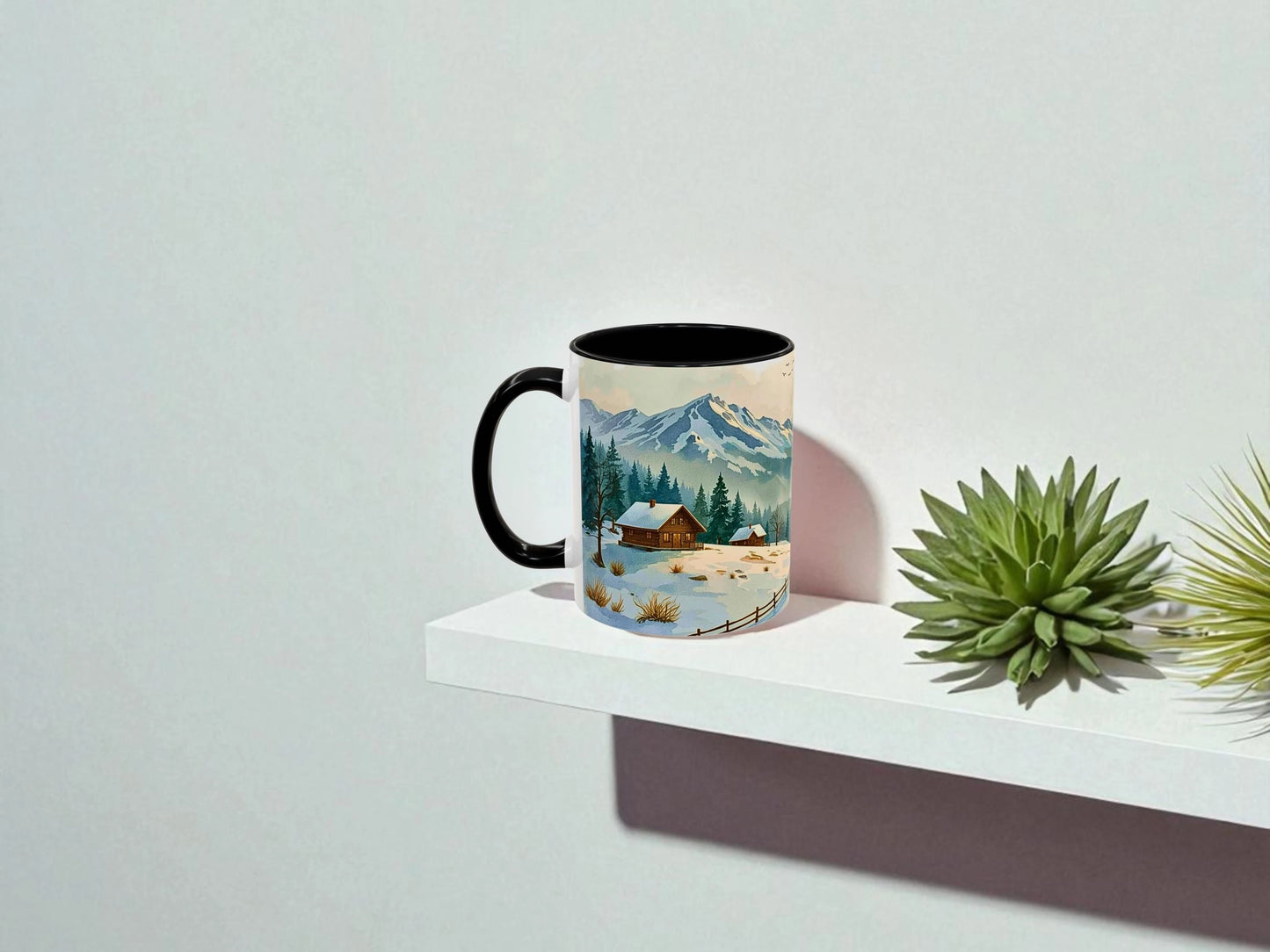 Mug with a scenic design of a mountain landscape on a white surface with a plant.