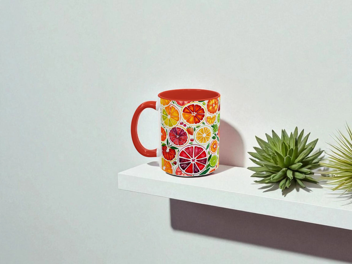 Colorful mug with fruit pattern on a white shelf against a light gray background