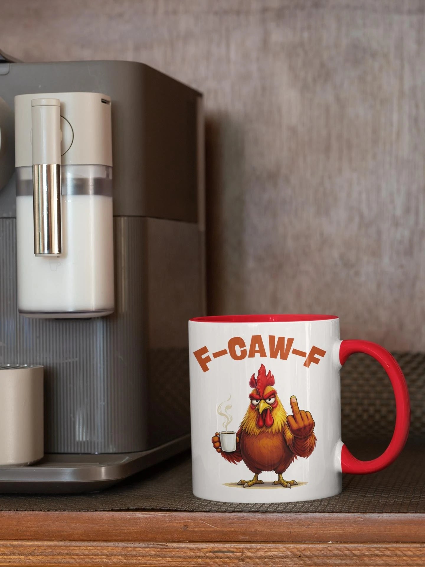 Mug with a cartoon rooster and 'F-CAW-F' text next to a coffee machine.