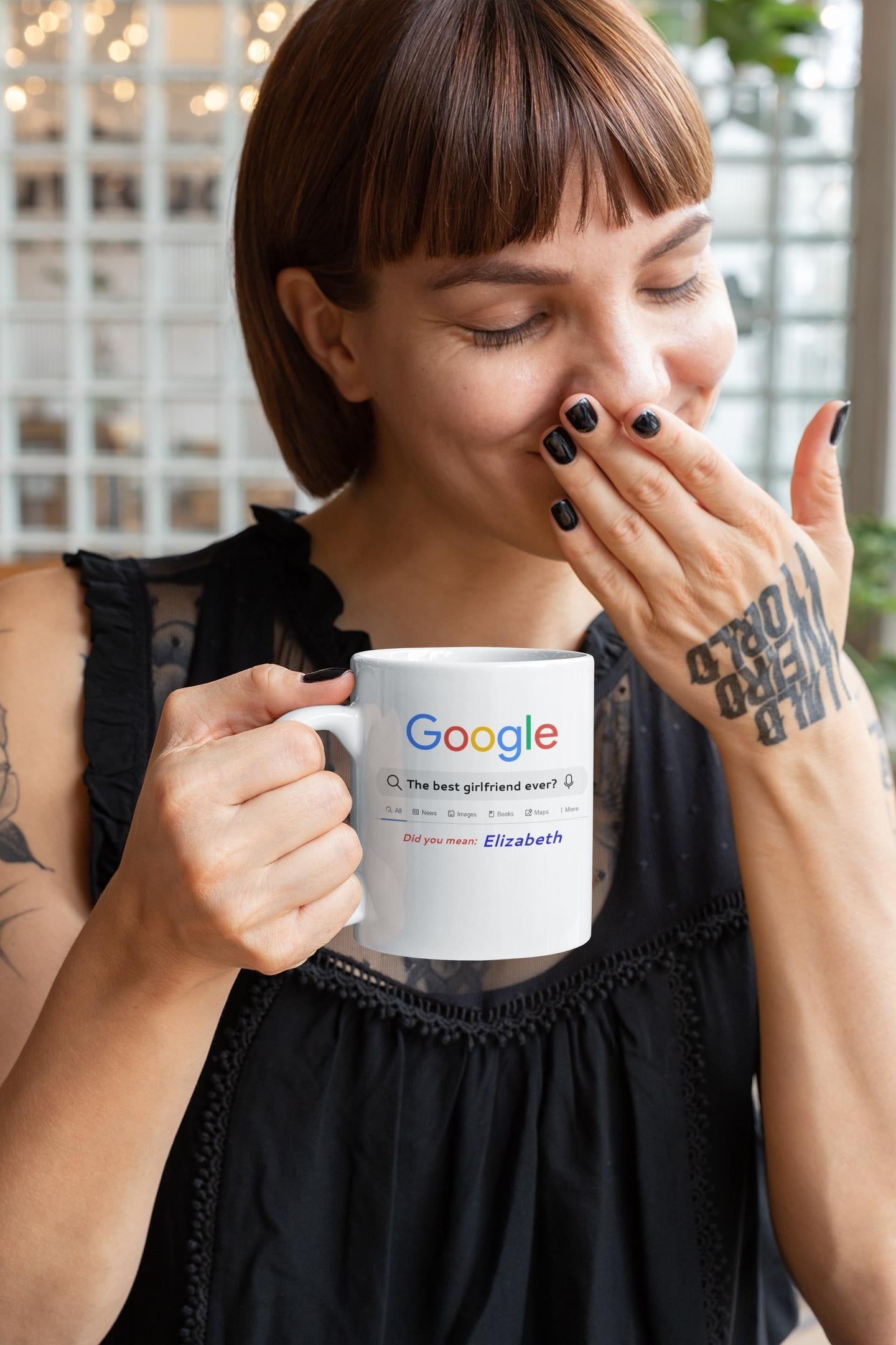 Woman holding a mug with Google logo and text, indoors.