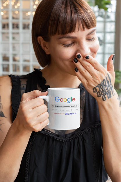 Woman holding a mug with Google logo and text, indoors.