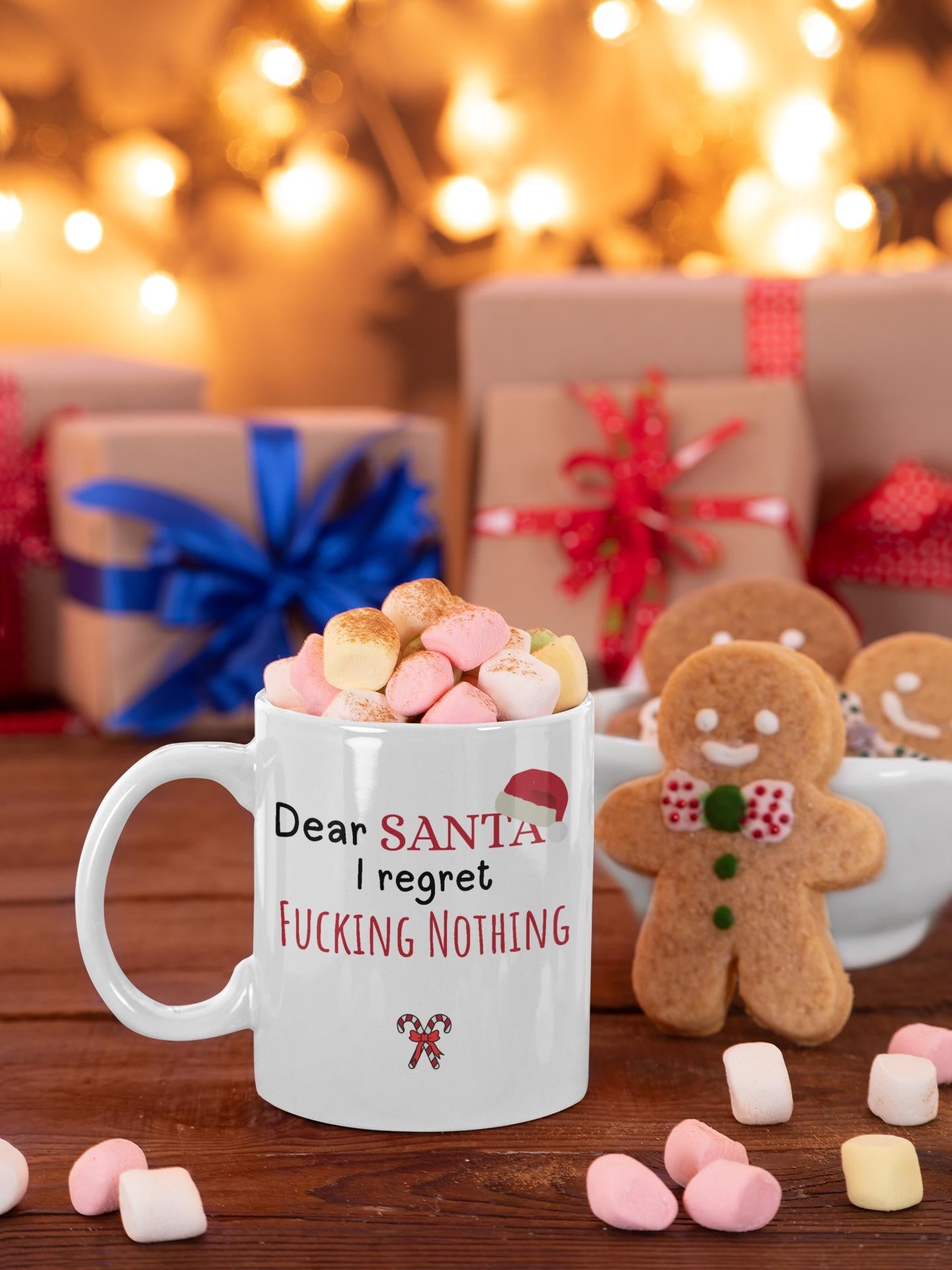 Mug with humorous text, marshmallows, and gingerbread men on a festive background.