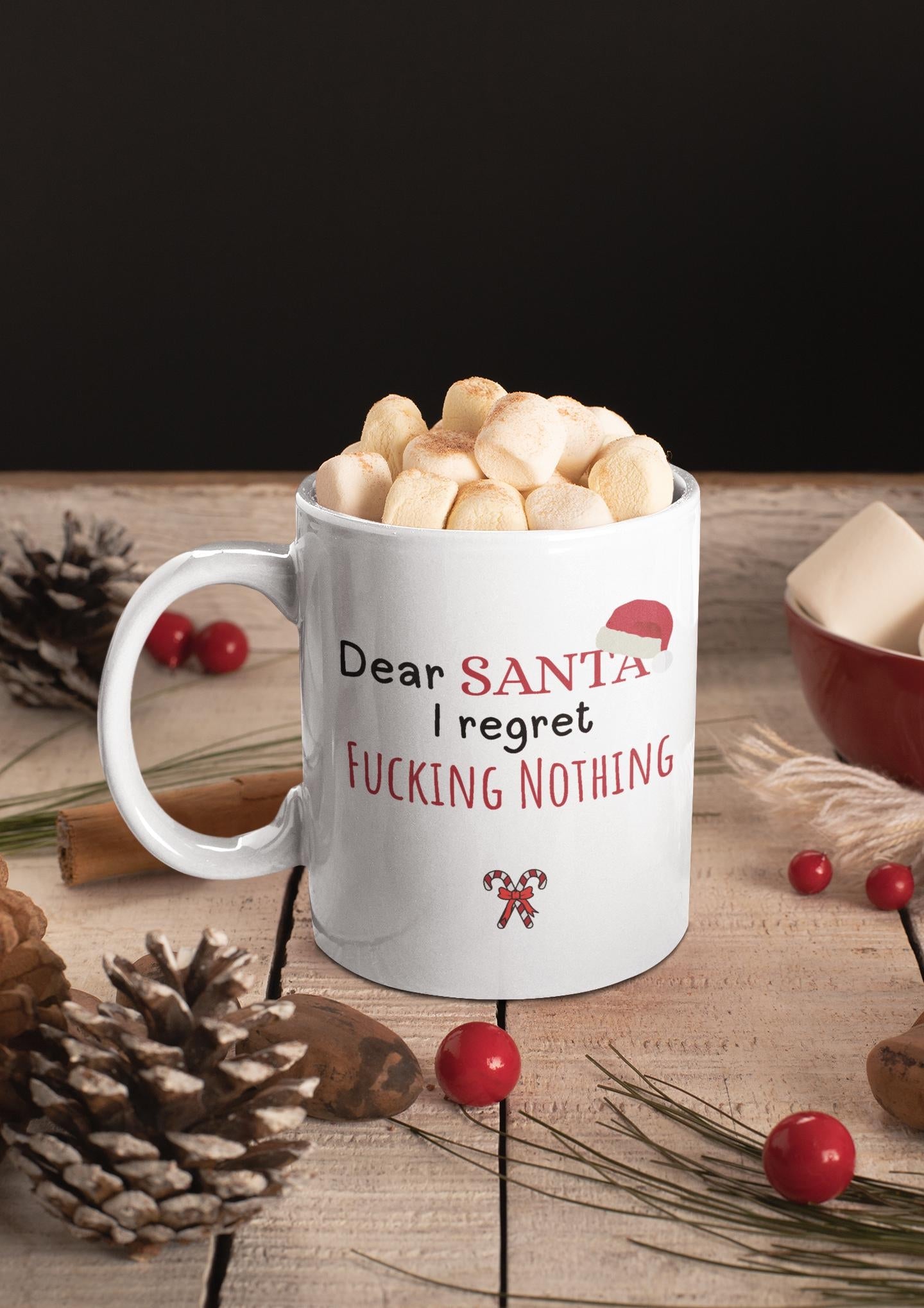 White mug with humorous text on a wooden surface with Christmas decorations