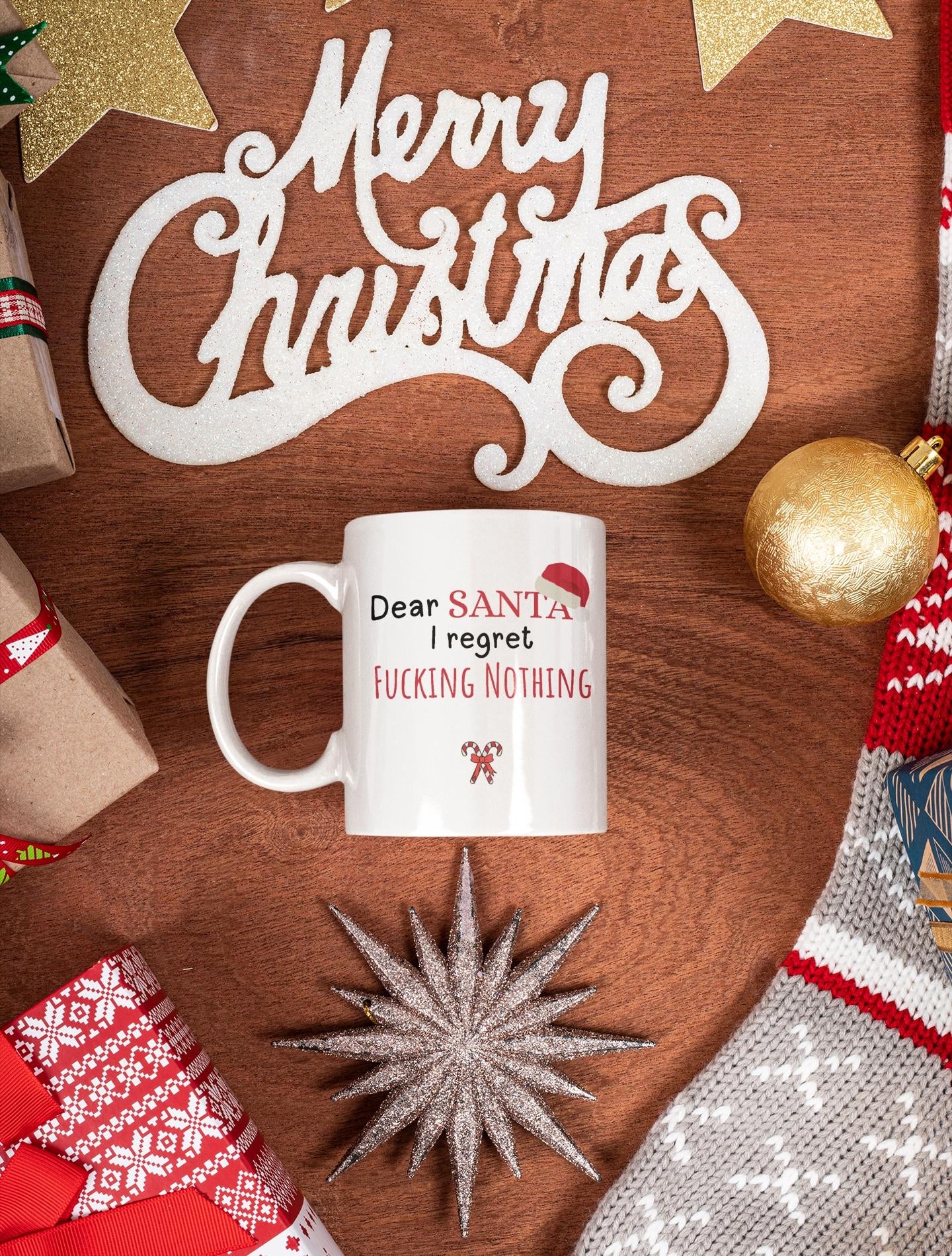 White mug with humorous text on a wooden surface with Christmas decorations