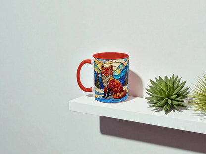 Mug with stained glass fox design on a white shelf with a plant