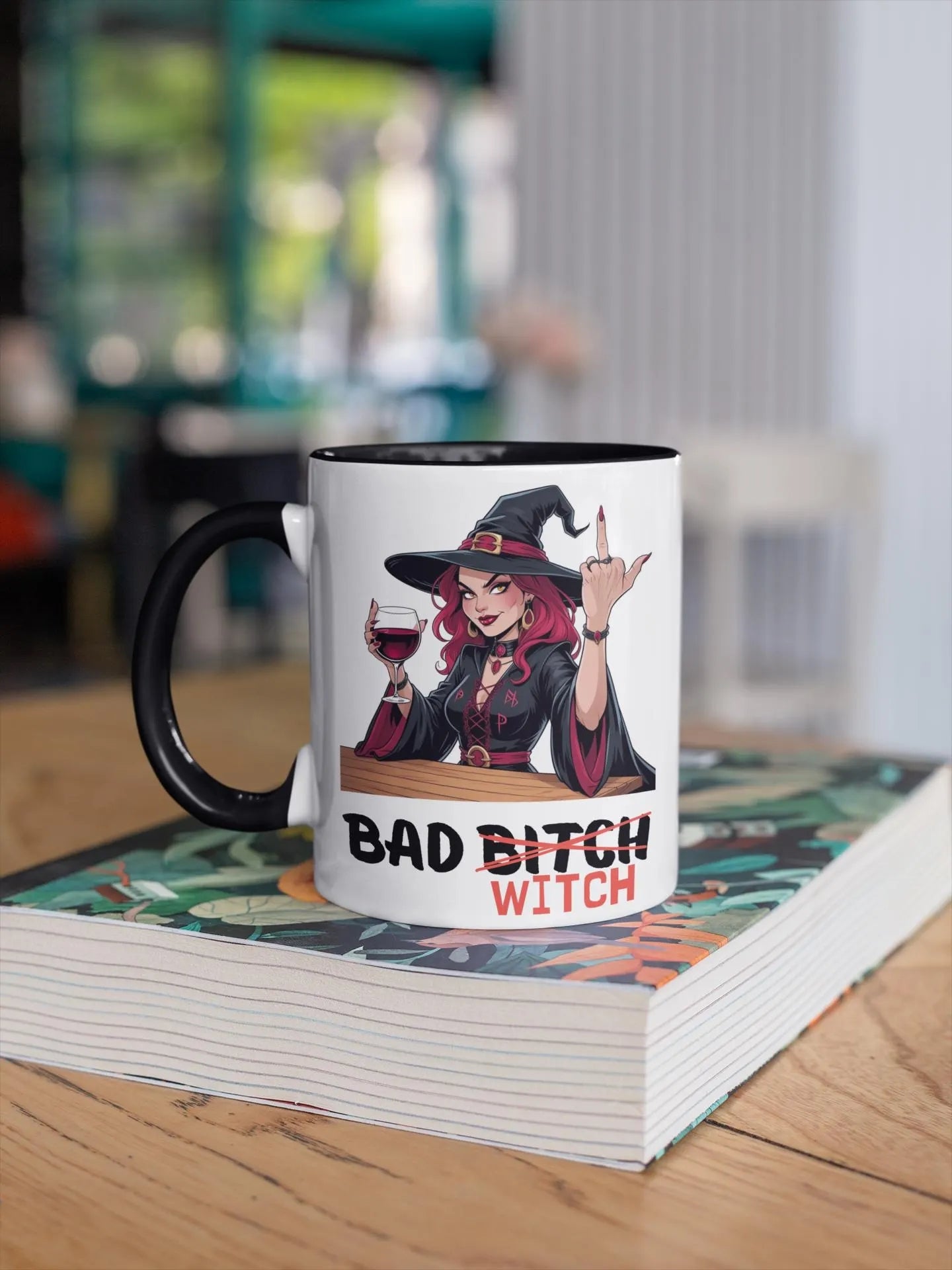 Mug with a graphic of a witch holding a glass of wine and the text 'Bad Bitch Witch' on a book.
