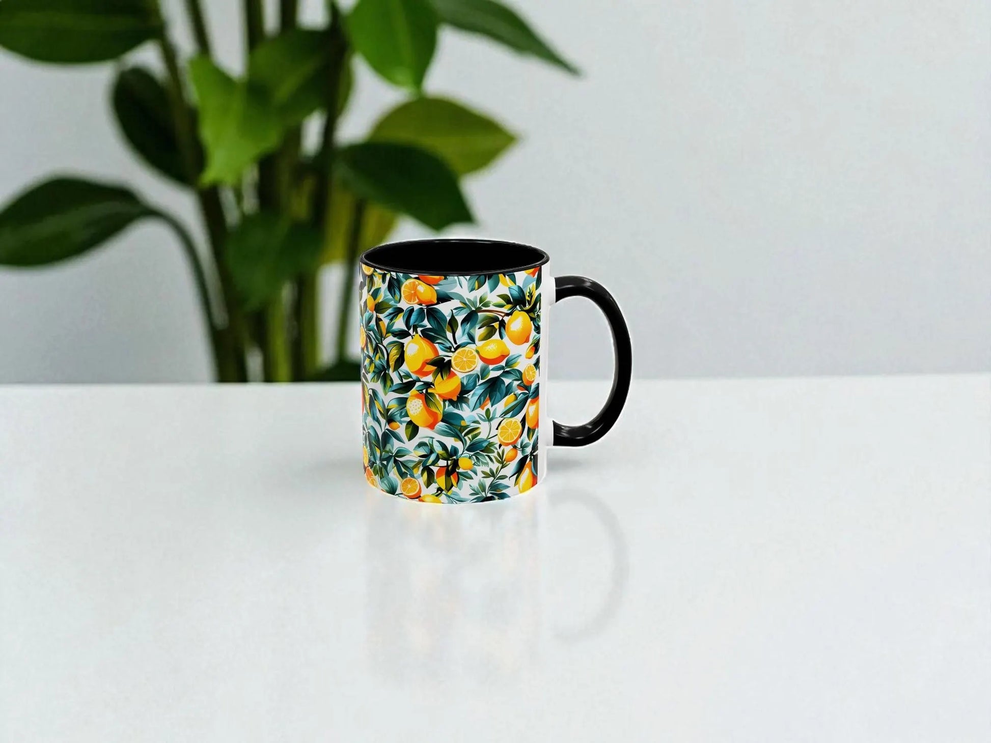 Mug with floral pattern on a white surface with a plant in the background