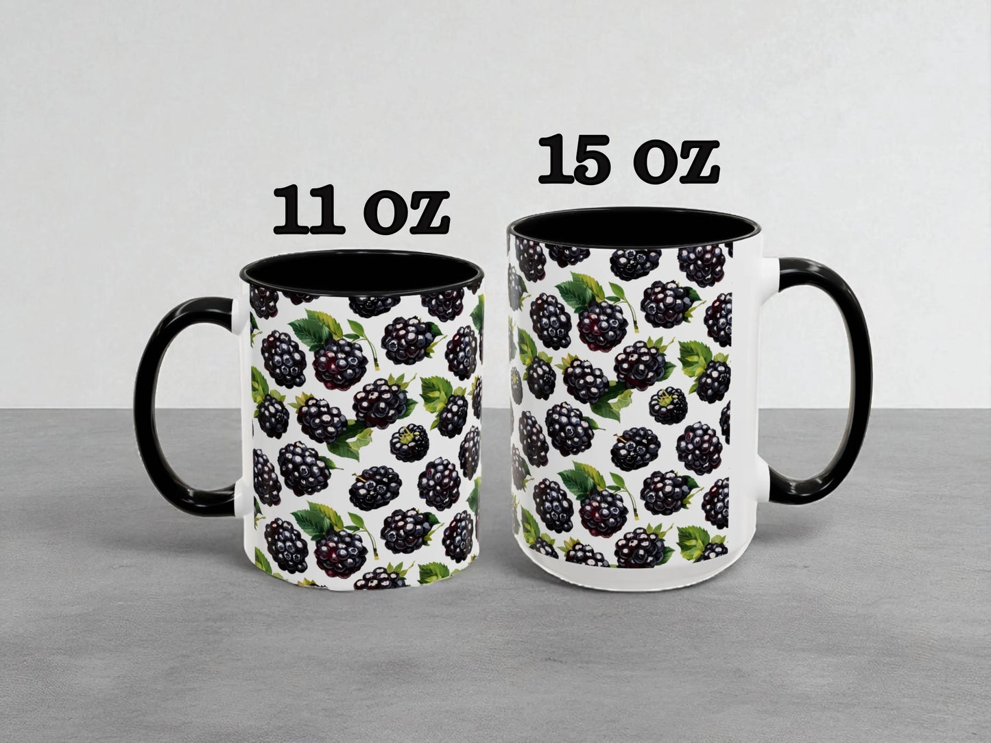 Two mugs with blackberry pattern, one labeled 11 oz and the other labeled 15 oz, on a gray background.