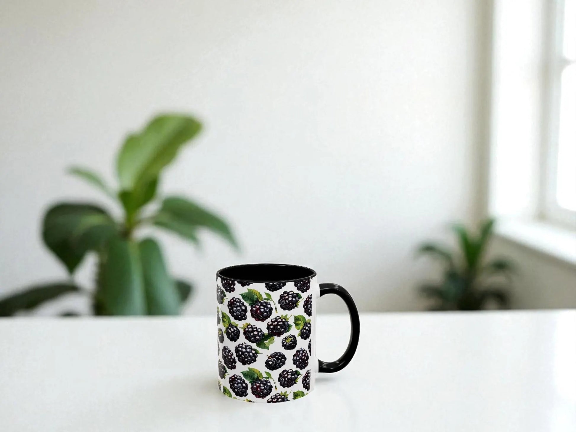 Mug with blackberry pattern on a white surface with plants in the background