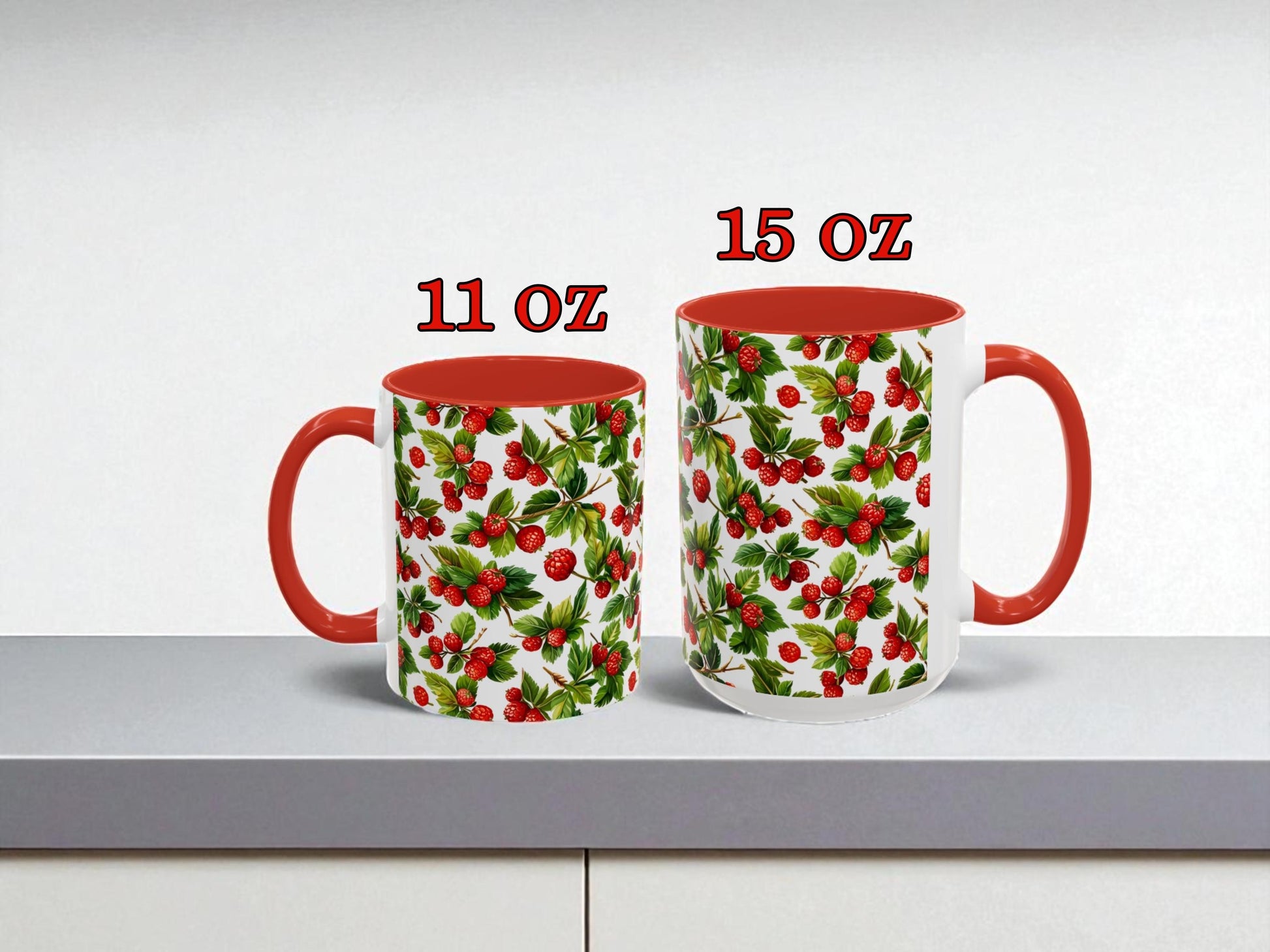 Two mugs with red interior and floral pattern on a white surface, labeled 11 oz and 15 oz.