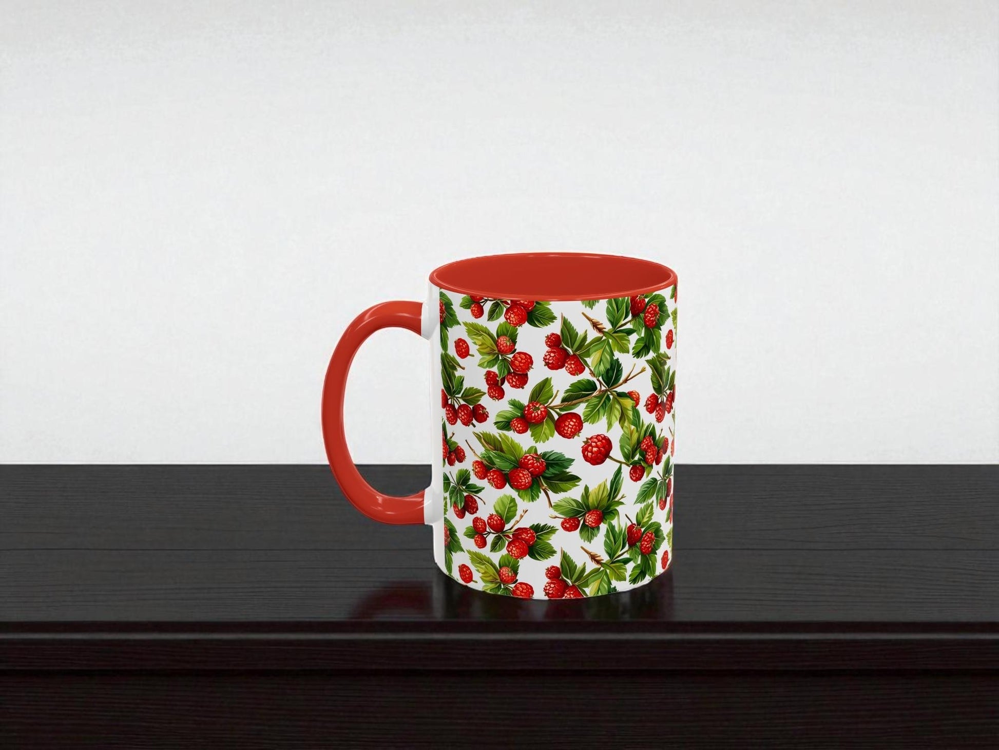 Mug with red handle and holly berry pattern on a white background