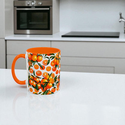 Mug with an orange design on a white surface with a plant