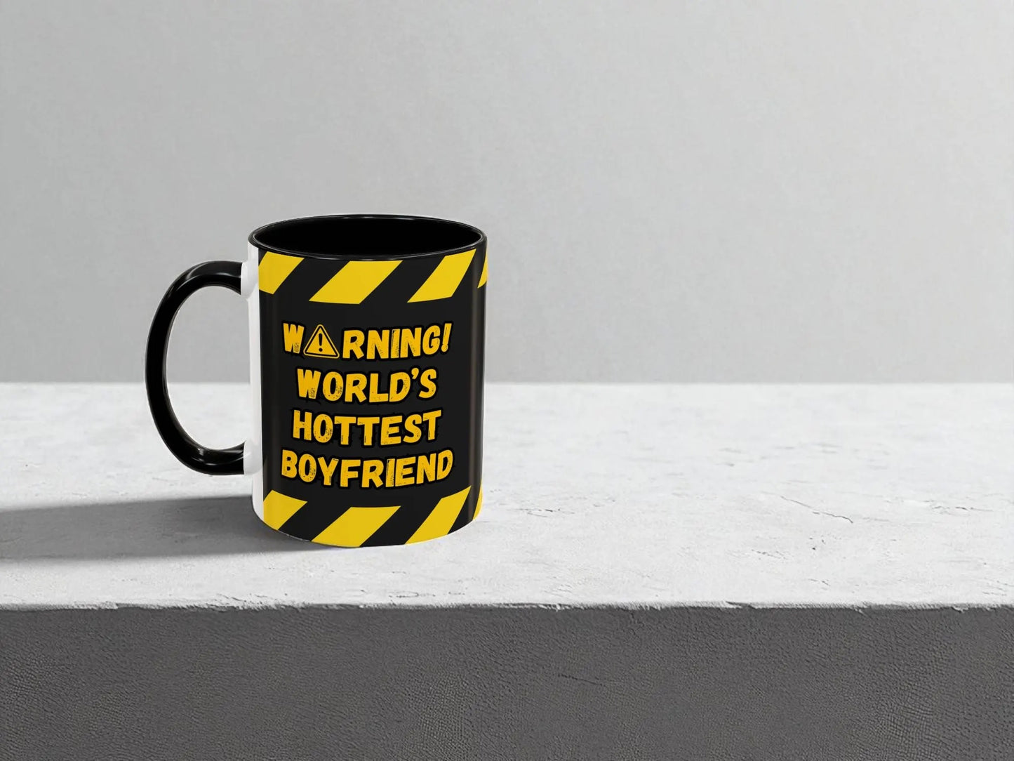 Black mug with yellow text and warning design on a gray background