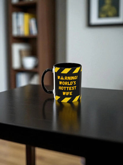 Mug with 'Warning: World's Hottest Wife' text on a table