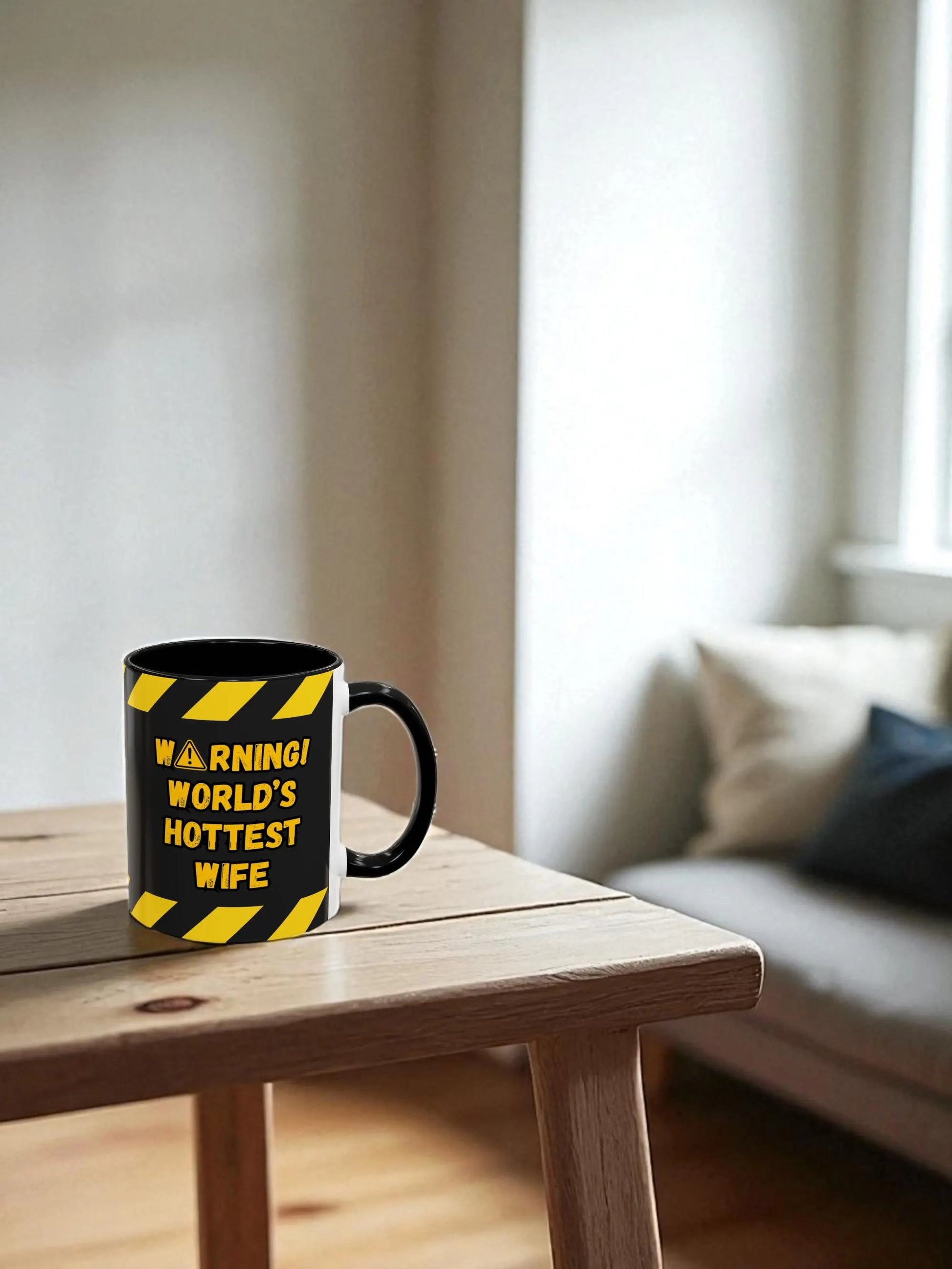 Mug with warning design on a wooden table in a living room