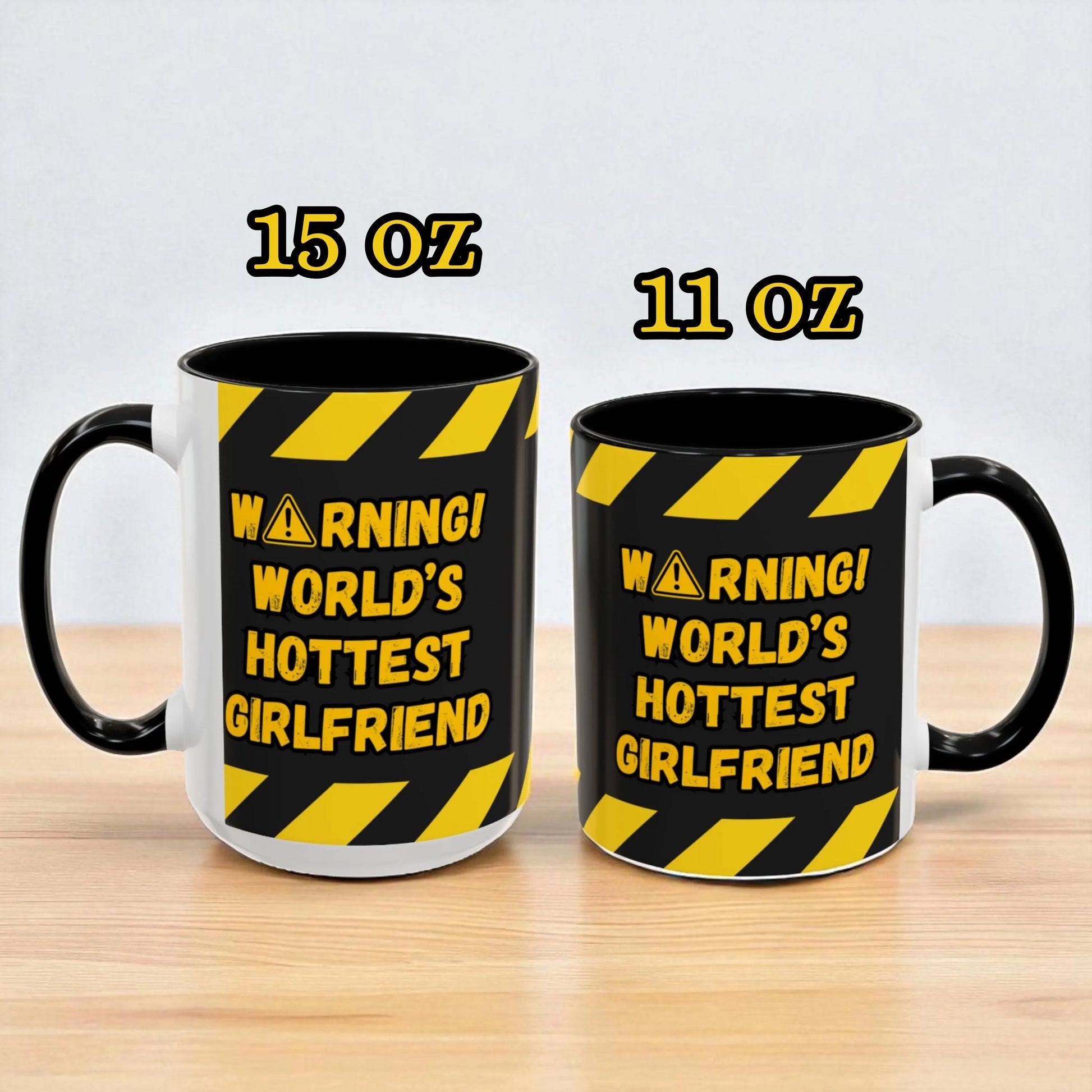 Two mugs with 'Warning! World's Hottest Girlfriend' text and different capacities on a light background.