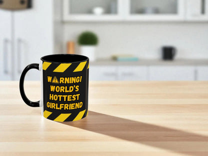 Mug with 'Warning! World's Hottest Girlfriend' text on a kitchen counter
