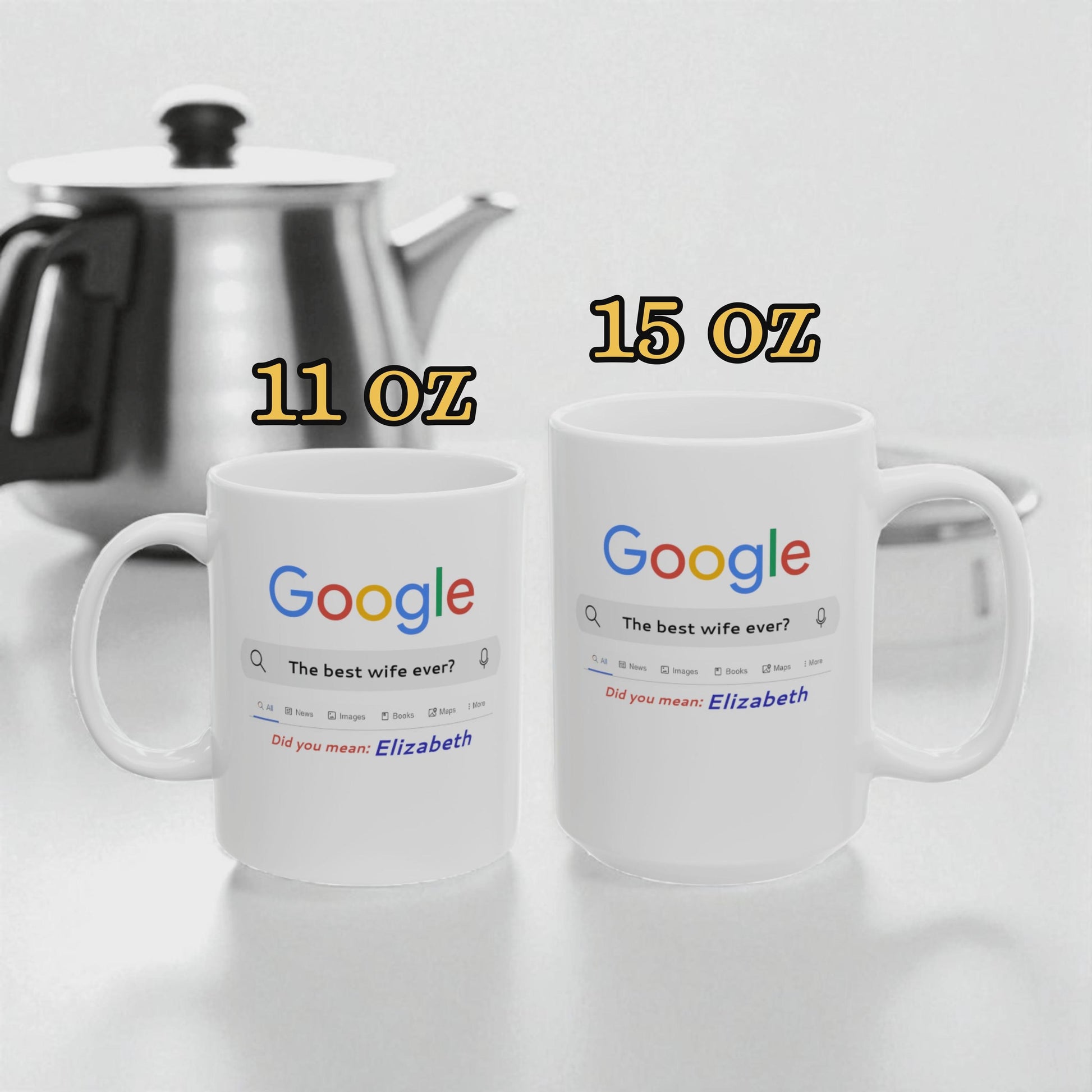 Two white mugs with Google search results printed on them, one labeled 11 oz and the other labeled 15 oz, next to a silver teapot.