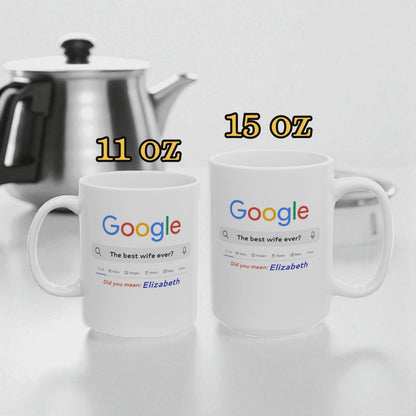 Two white mugs with Google search results printed on them, one labeled 11 oz and the other labeled 15 oz, next to a silver teapot.