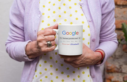 Person holding a mug with Google branding against a neutral background