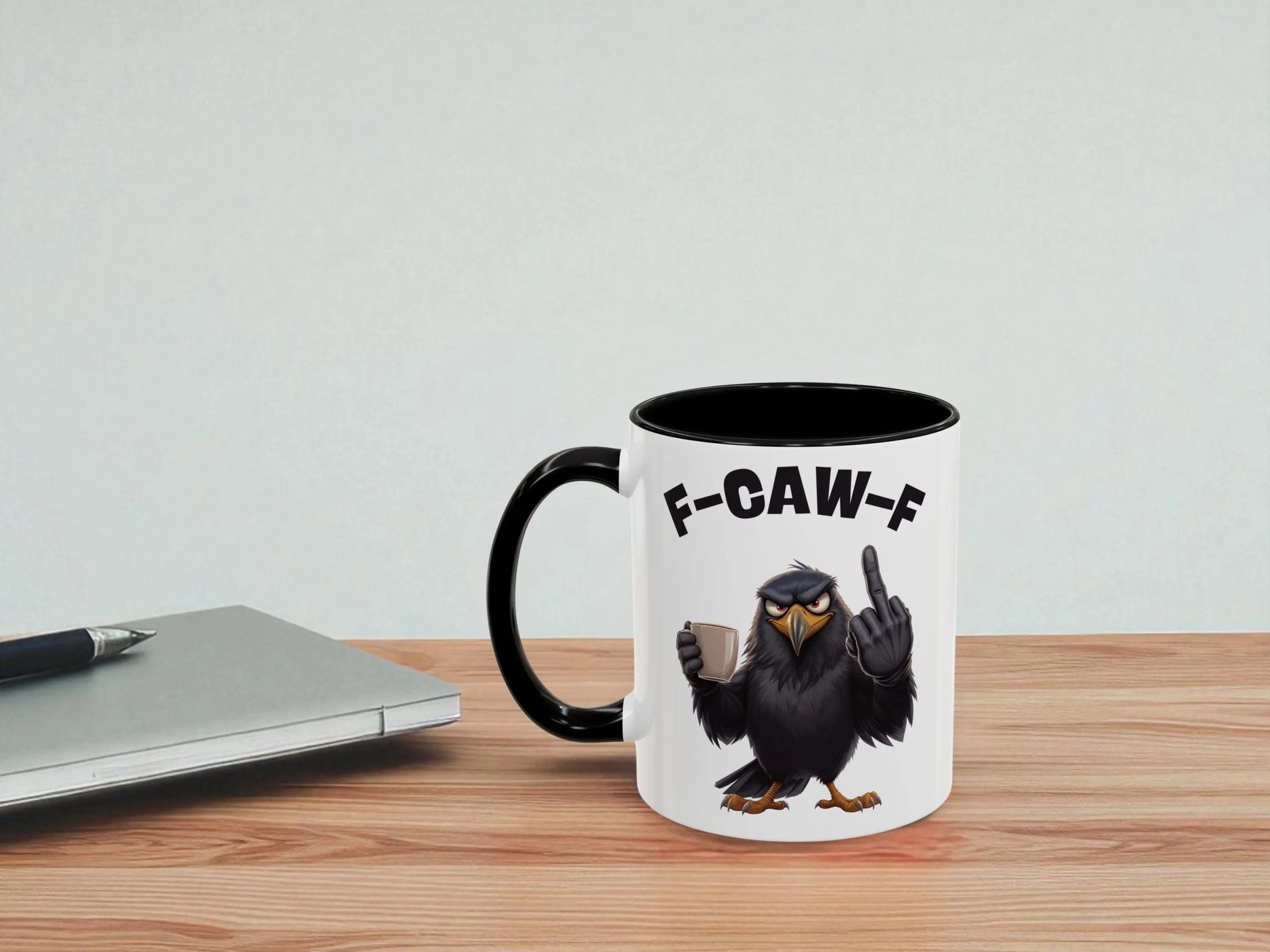 Mug with an eagle design and 'F-CAW-F' text on a wooden surface with a light gray background