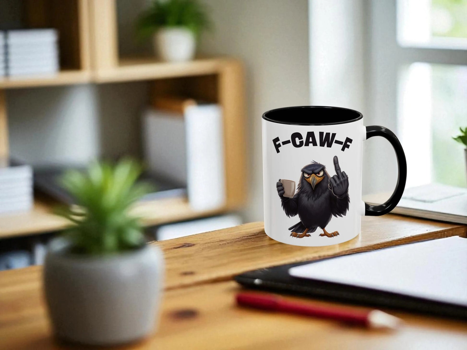 Mug with a bird design and text on a desk with office items