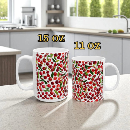 Two mugs with cherry pattern on a kitchen counter, labeled 15 oz and 11 oz.