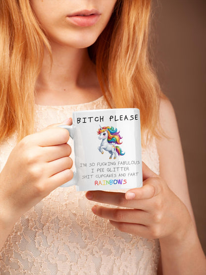 Person holding a mug with a colorful unicorn design and text.