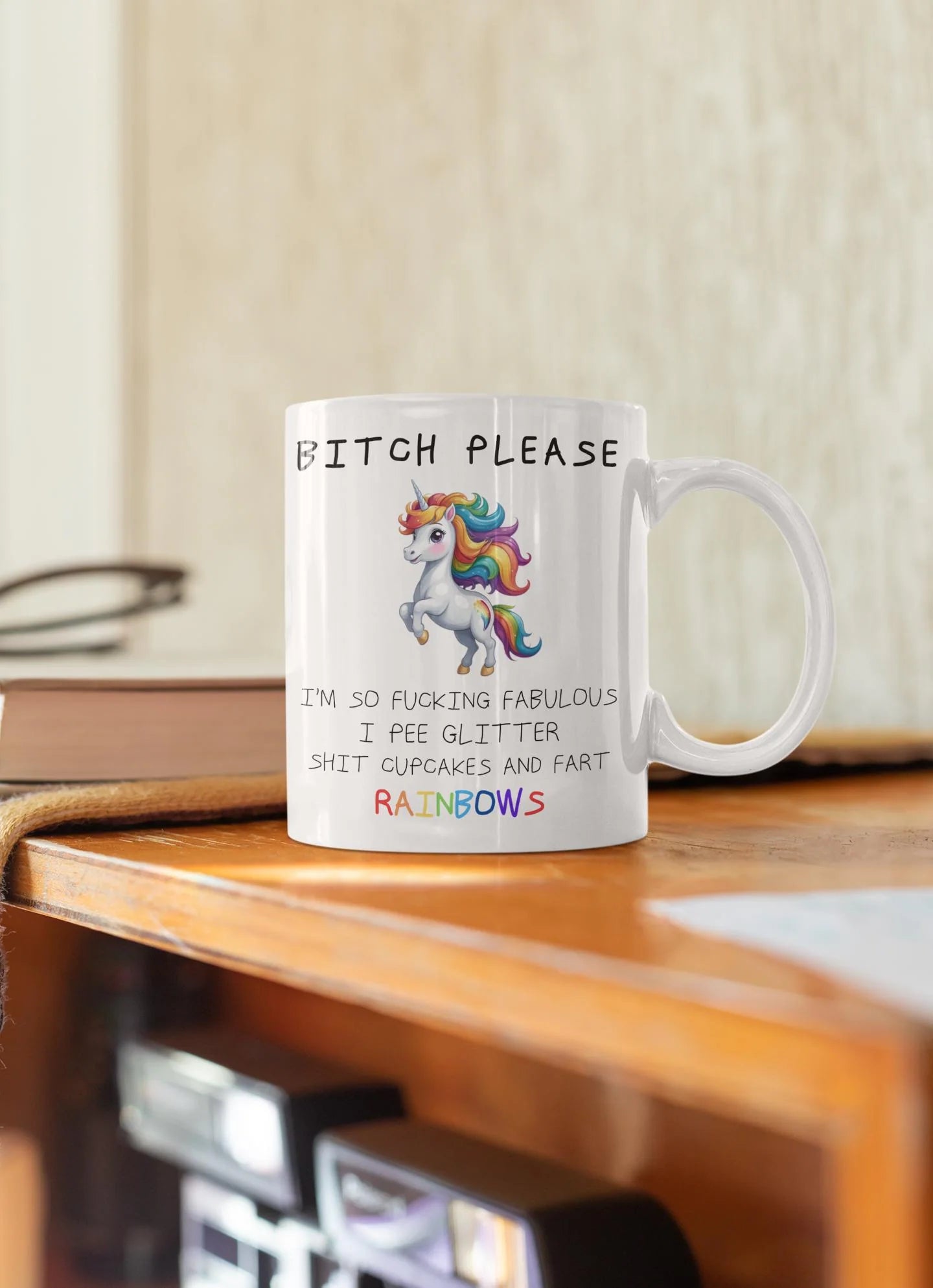 Mug with a colorful unicorn design and text on a wooden surface.