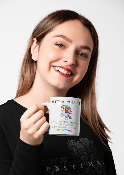 Woman holding a mug with a colorful design and text.